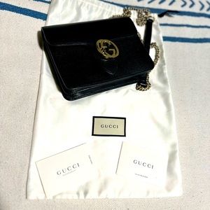I have a black Gucci crossbody handbag with chain strap. Like Brand New.